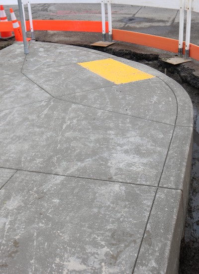 An ADA-accessible curb ramp is under construction