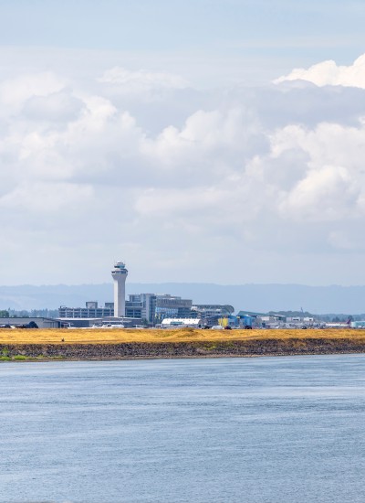 A view of the Portland Airport from the Columbia River on a lightly cloudy day