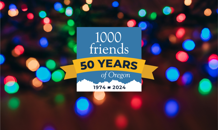 Twinkly multicolor lights glow behind 1000 Friends of Oregon's 50th anniversary logo